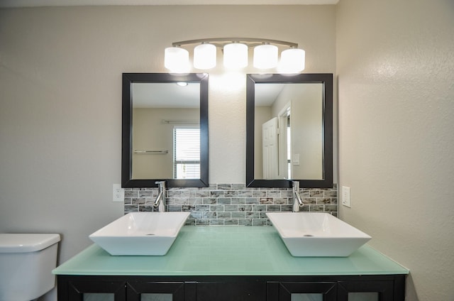9518 Prairie Dale Ct, Houston, TX 77075 - bathroom with tasteful backsplash, toilet, and double vanity