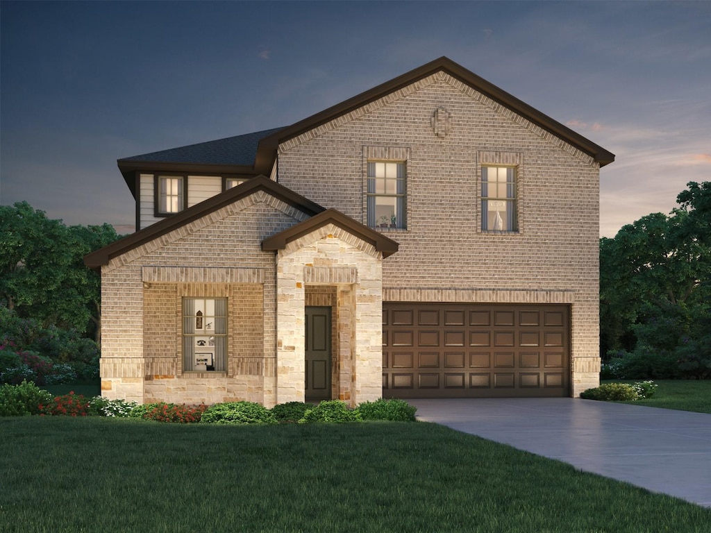 12111 Willow Hollow Ln, Baytown, TX 77523 - view of front of home with a yard, a garage, driveway, and brick siding