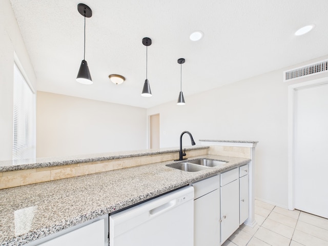 kitchen with white cabinetry, visible vents, a sink, white dishwasher, and decorative light fixtures