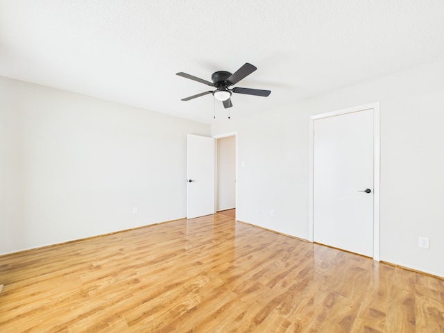 spare room featuring ceiling fan and wood finished floors