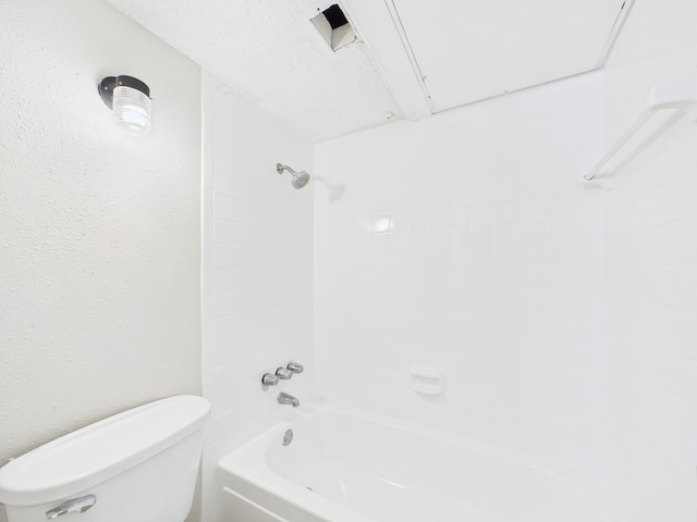 bathroom with washtub / shower combination and toilet