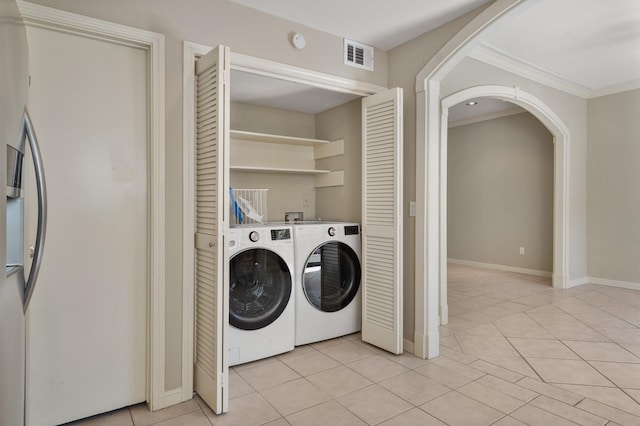 11711 Memorial Dr Unit 367, Houston, TX 77024 - laundry room with laundry area, arched walkways, ornamental molding, visible vents, and washer and dryer