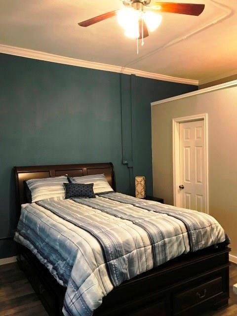 3522 Sampson St, Houston, TX 77004 - bedroom with wood finished floors, a ceiling fan, baseboards, and ornamental molding