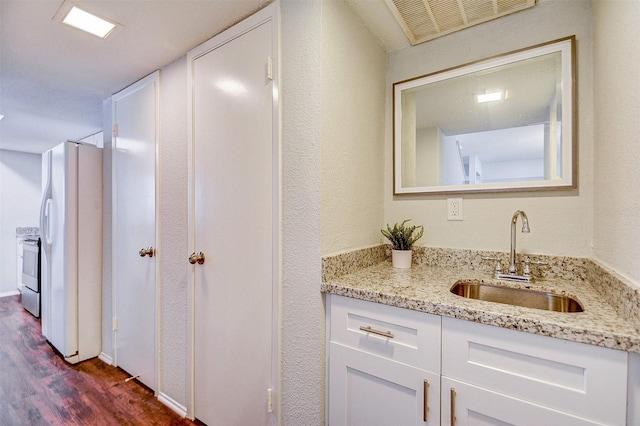 bathroom featuring wood finished floors, vanity, and visible vents