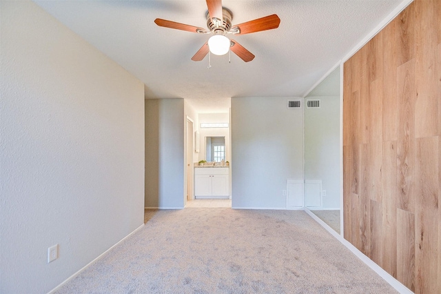 unfurnished room with light colored carpet, ceiling fan, and visible vents