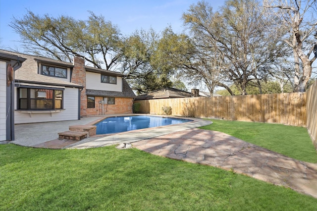 view of swimming pool featuring a fenced in pool, a patio area, a fenced backyard, and a lawn