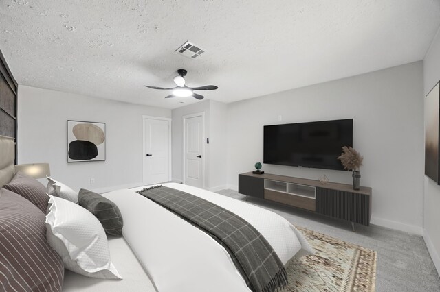 carpeted bedroom with visible vents, baseboards, a textured ceiling, and ceiling fan
