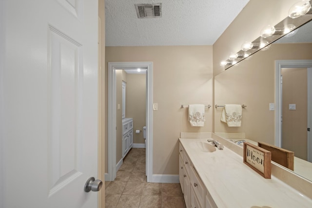 2331 Sand Ct, Richmond, TX 77406 - bathroom featuring a textured ceiling, vanity, visible vents, toilet, and tile patterned floors