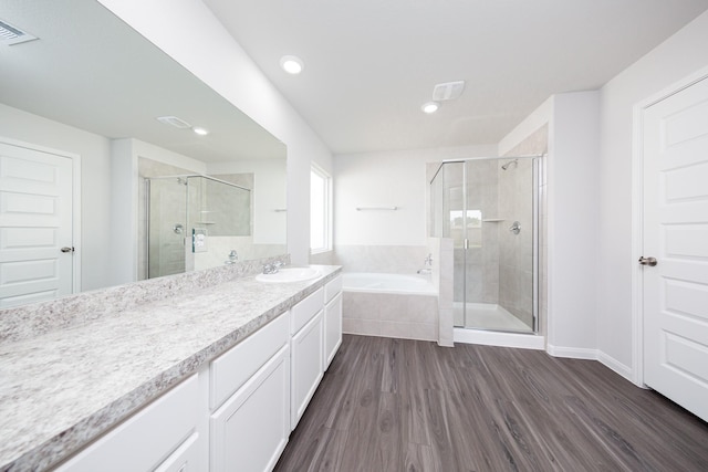 16547 Willow Forest Dr, Conroe, TX 77302 - bathroom with a bath, vanity, a stall shower, wood finished floors, and recessed lighting