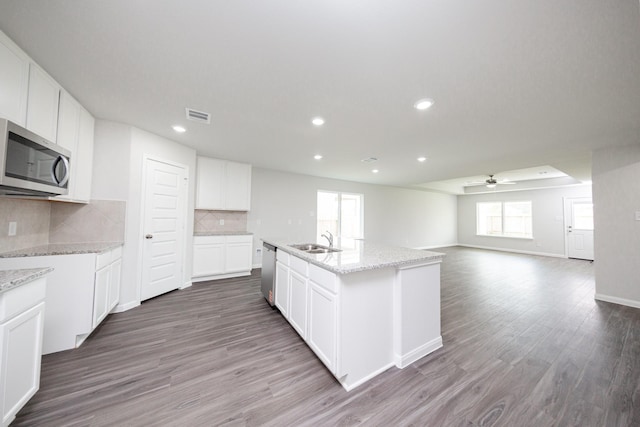 16547 Willow Forest Dr, Conroe, TX 77302 - kitchen with stainless steel appliances, ceiling fan, wood finished floors, tasteful backsplash, and recessed lighting