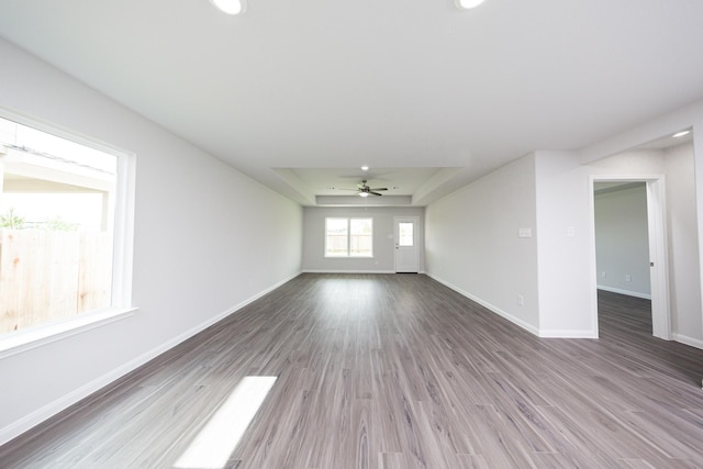 16547 Willow Forest Dr, Conroe, TX 77302 - unfurnished living room featuring a raised ceiling, a ceiling fan, wood finished floors, and recessed lighting