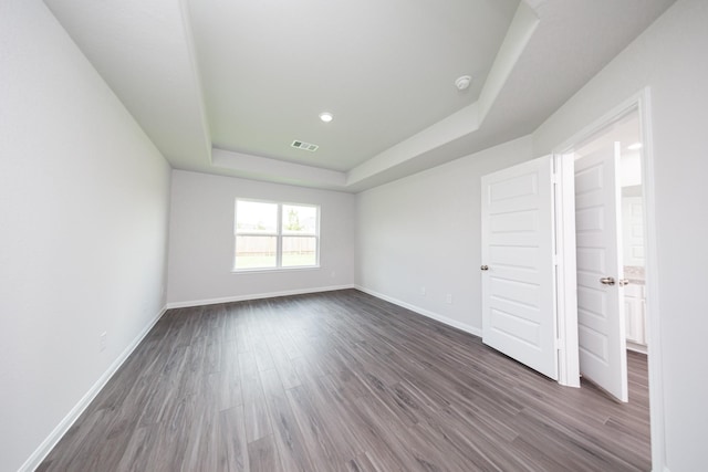 16547 Willow Forest Dr, Conroe, TX 77302 - unfurnished bedroom with a tray ceiling and dark wood finished floors