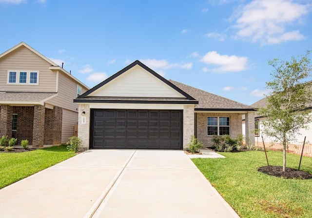 16547 Willow Forest Dr, Conroe, TX 77302 - ranch-style home with brick siding, a garage, concrete driveway, and a front yard