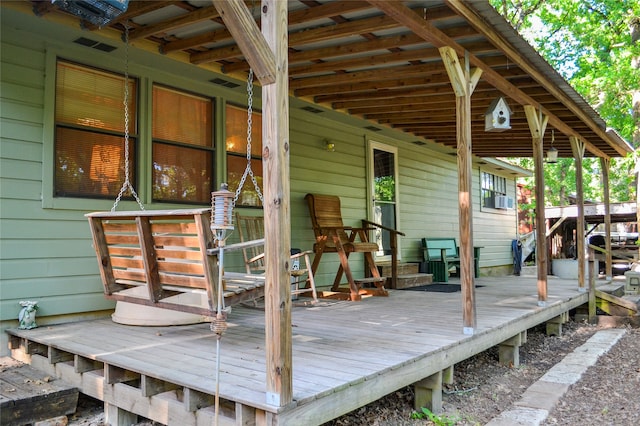 wooden terrace featuring visible vents