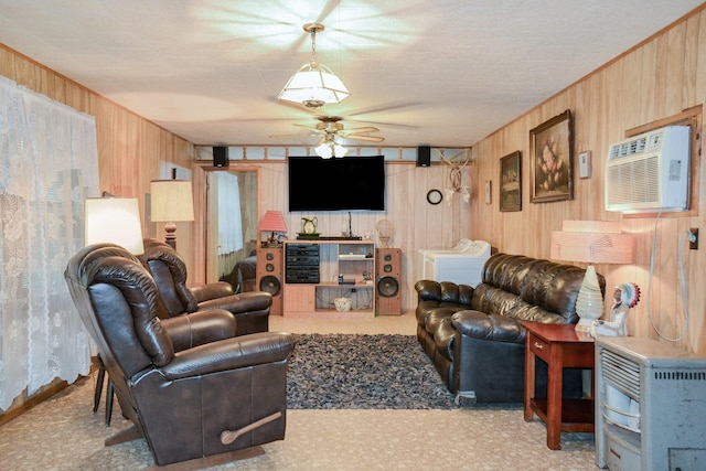 living area featuring an AC wall unit, a ceiling fan, and wood walls