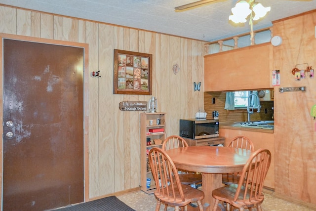 dining area featuring wooden walls