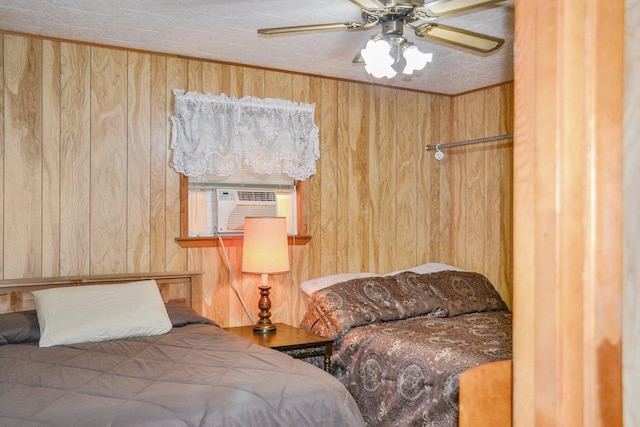 bedroom featuring a ceiling fan, cooling unit, and wooden walls