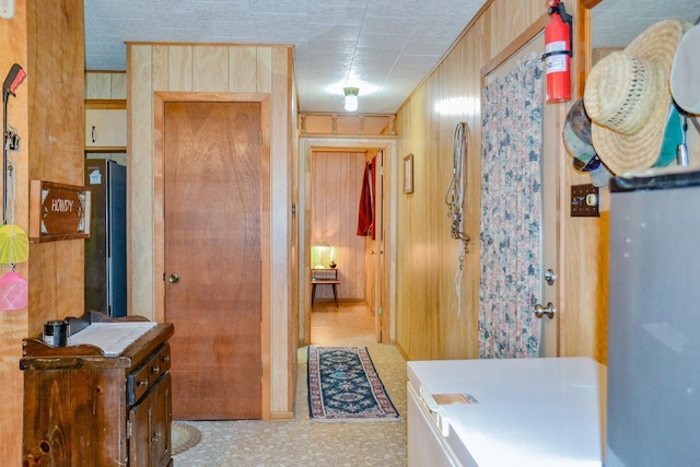hall with tile patterned floors