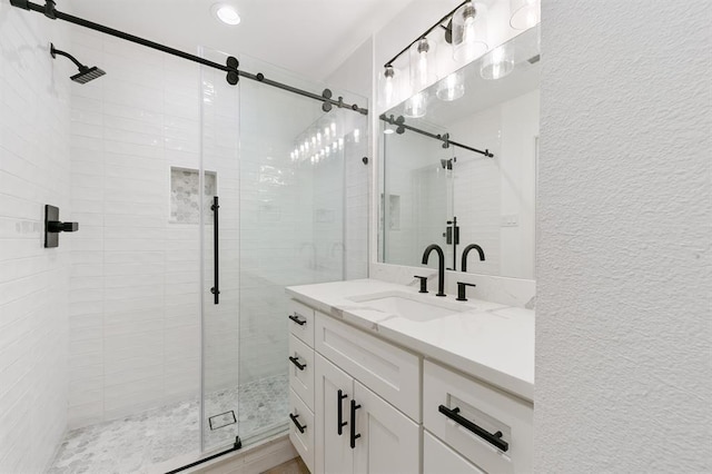5338 Pease St, Houston, TX 77023 - full bathroom featuring a shower stall, vanity, a textured wall, and recessed lighting