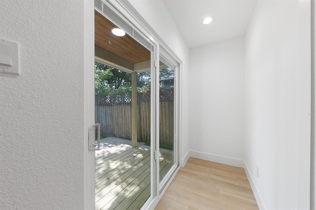 5338 Pease St, Houston, TX 77023 - doorway to outside featuring a textured wall, baseboards, recessed lighting, and light wood-style floors