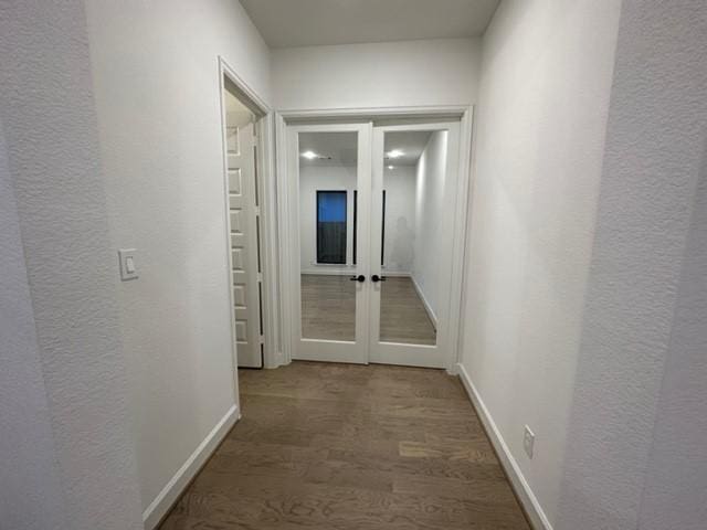 9015 Orchard Cv, Missouri City, TX 77459 - corridor featuring a textured wall, french doors, baseboards, and wood finished floors