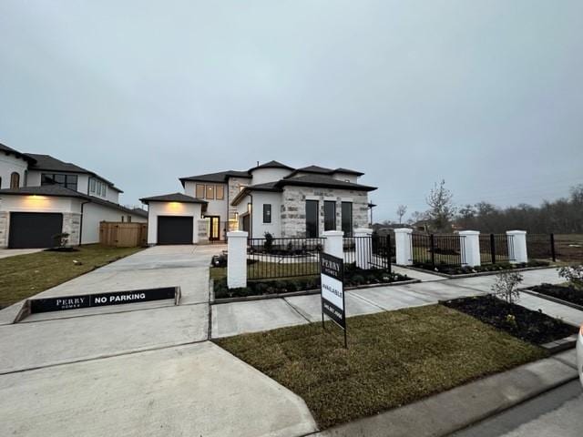 9015 Orchard Cv, Missouri City, TX 77459 - view of front of home featuring a garage, driveway, and a fenced front yard
