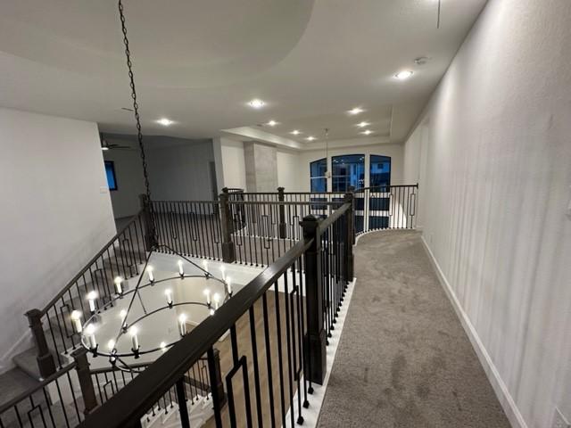 9015 Orchard Cv, Missouri City, TX 77459 - hallway featuring an upstairs landing, carpet, and recessed lighting