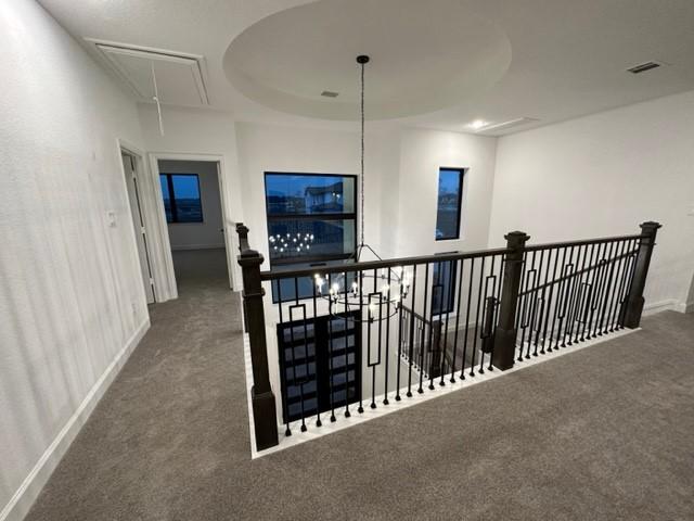 9015 Orchard Cv, Missouri City, TX 77459 - hallway with visible vents, attic access, carpet flooring, an upstairs landing, and baseboards