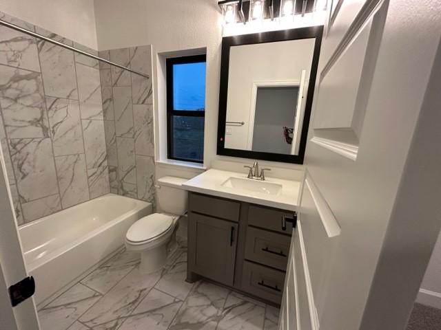 9015 Orchard Cv, Missouri City, TX 77459 - full bathroom with bathtub / shower combination, vanity, marble finish floor, and toilet