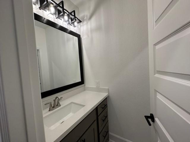 9015 Orchard Cv, Missouri City, TX 77459 - bathroom with vanity and baseboards