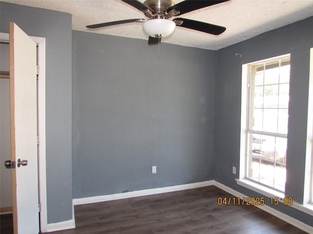 spare room with ceiling fan, baseboards, and wood finished floors