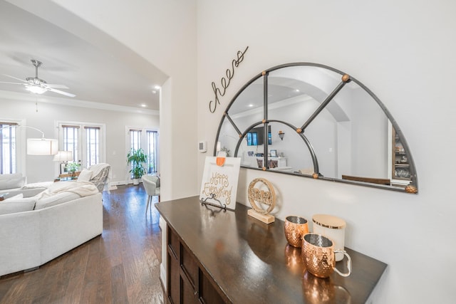 interior space with recessed lighting, dark wood-style flooring, a ceiling fan, ornamental molding, and arched walkways