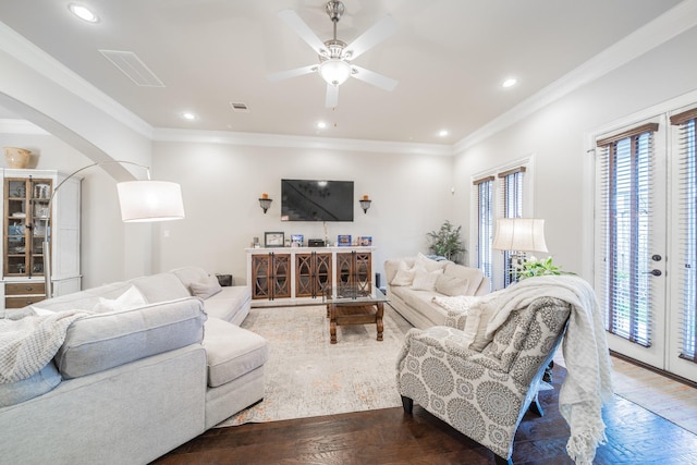 living area with hardwood / wood-style floors, recessed lighting, and arched walkways