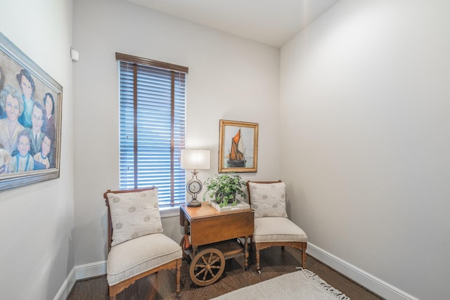 living area with wood finished floors and baseboards