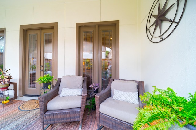 property entrance featuring french doors, stucco siding, and a porch