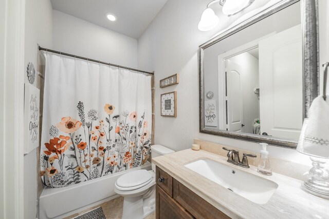 full bathroom featuring shower / bath combo, vanity, and toilet
