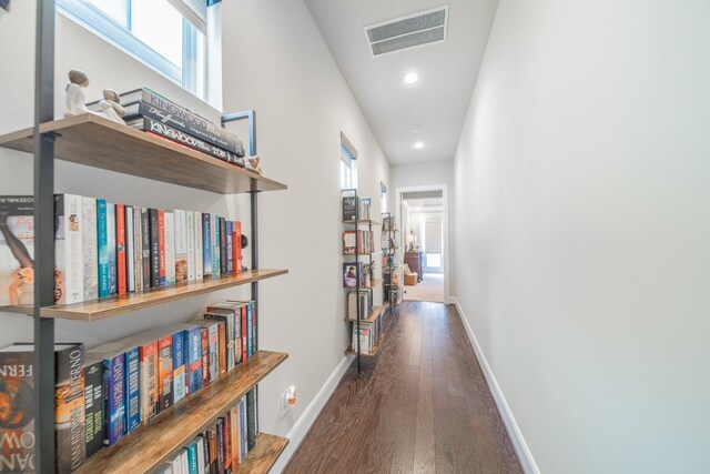 corridor with recessed lighting, wood finished floors, plenty of natural light, baseboards, and visible vents