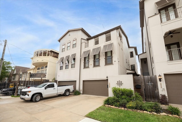 view of front of home featuring stucco siding, concrete driveway, and a garage