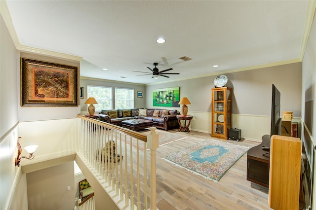 16123 Chasemore Dr, Spring, TX 77379 - living area with a wainscoted wall, crown molding, wood finished floors, a ceiling fan, and recessed lighting