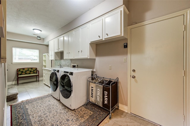 16123 Chasemore Dr, Spring, TX 77379 - washroom with cabinet space, independent washer and dryer, a textured ceiling, baseboards, and light tile patterned flooring