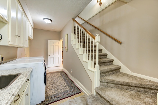 16123 Chasemore Dr, Spring, TX 77379 - washroom featuring cabinet space, separate washer and dryer, baseboards, and a textured ceiling