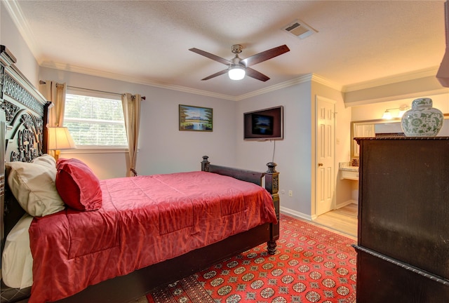 16123 Chasemore Dr, Spring, TX 77379 - bedroom with crown molding, ensuite bathroom, baseboards, and a ceiling fan