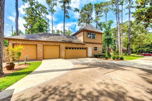 16123 Chasemore Dr, Spring, TX 77379 - view of front of home featuring brick siding, driveway, and an attached garage