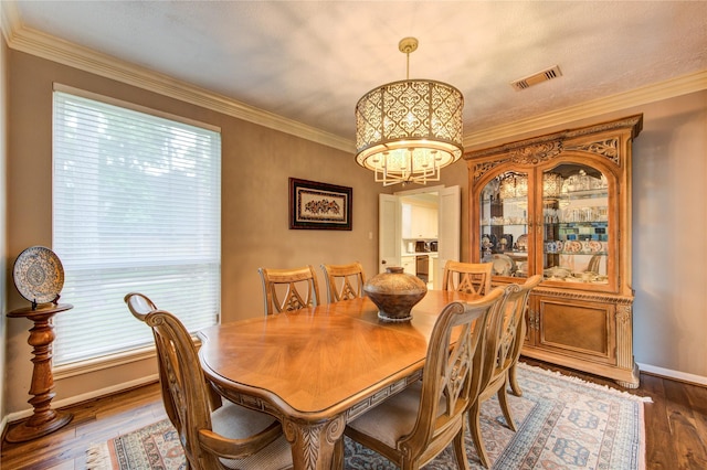 16123 Chasemore Dr, Spring, TX 77379 - dining area with a chandelier, dark wood-type flooring, baseboards, and crown molding