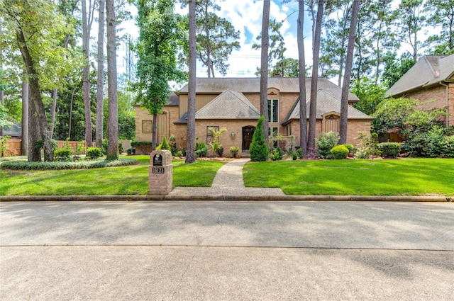 16123 Chasemore Dr, Spring, TX 77379 - tudor house featuring a front lawn and brick siding