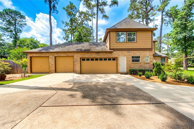 16123 Chasemore Dr, Spring, TX 77379 - view of front of house featuring driveway, brick siding, an attached garage, and roof with shingles