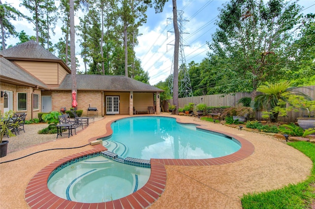 16123 Chasemore Dr, Spring, TX 77379 - view of swimming pool with french doors, a fenced backyard, a patio area, and a pool with connected hot tub