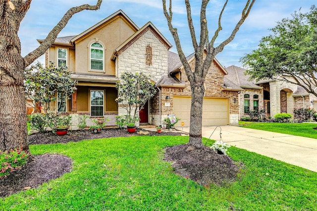 2011 Wembley Way, Rosenberg, TX 77471 - view of front facade featuring driveway, a front yard, a garage, stone siding, and stucco siding