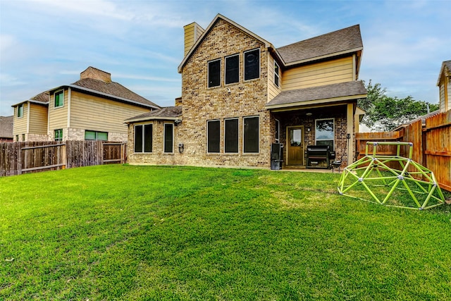 2011 Wembley Way, Rosenberg, TX 77471 - rear view of property with a lawn, a shingled roof, a chimney, and a fenced backyard