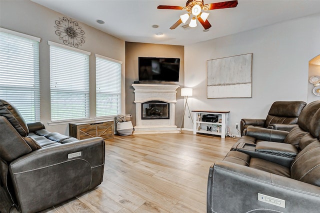2011 Wembley Way, Rosenberg, TX 77471 - living room with a glass covered fireplace, ceiling fan, wood finished floors, and a healthy amount of sunlight